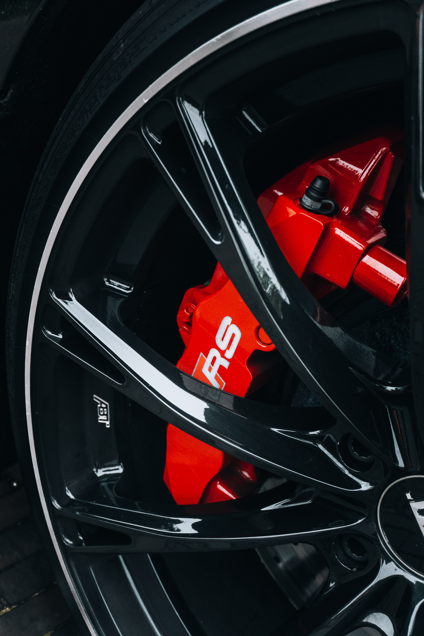 This image shows a close up of a wheel with a red caliper painted on the inside. The subheading talks about saftey.